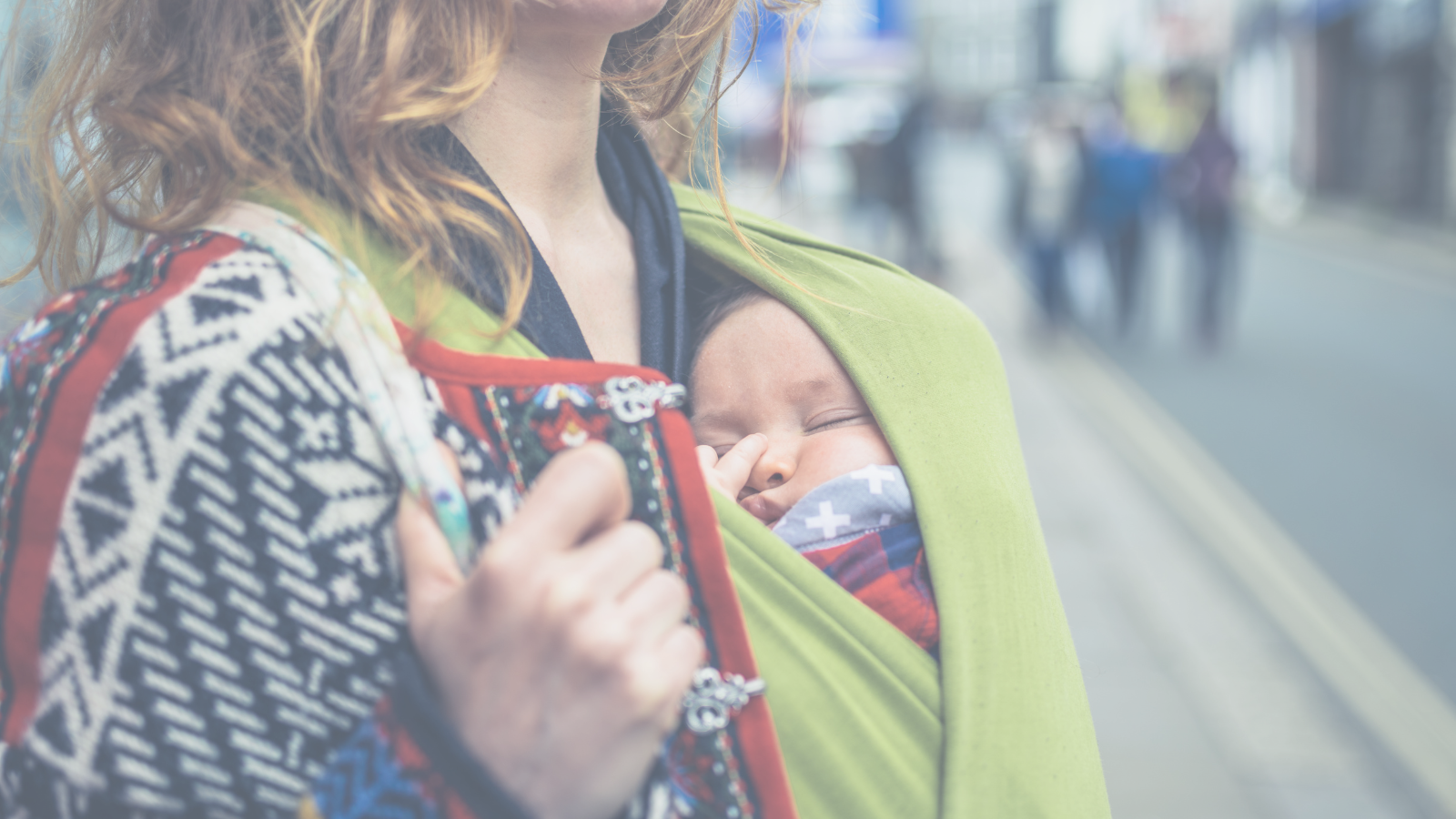 Mother holding her baby in a sling,